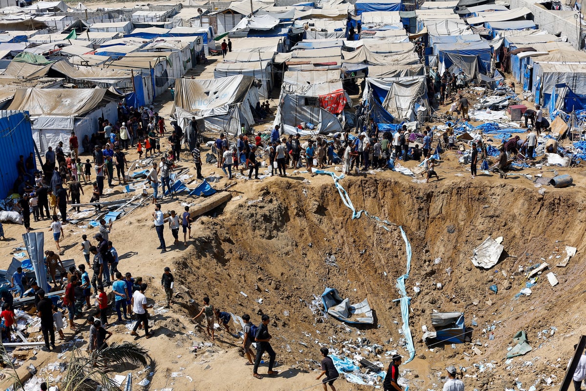 Palestinians inspect overnight Israeli strike on medicine warehouse at Al-Aqsa Martyrs Hospital, Deir el-Balah, Gaza