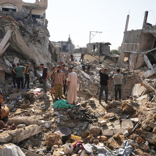 Palestinians inspect destroyed buildings at Maghazi refugee camp in central Gaza following Israeli air strikes, August 2026