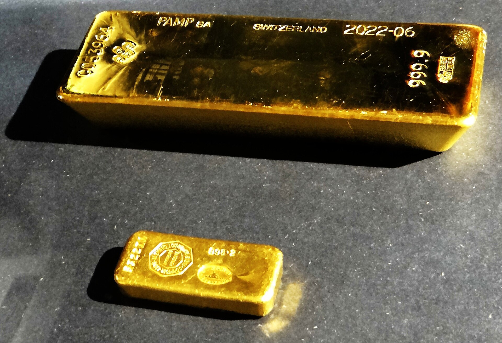Gold price today: a PAMP Switzerland 999.9 cast gold bar dated 2022-06 beside a smaller stamped gold bar at the Banque de France