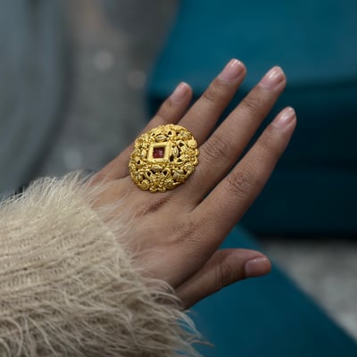 A woman wears a large one gram gold ring, the lighter jewellery Indian buyers turn to at the gold rate today