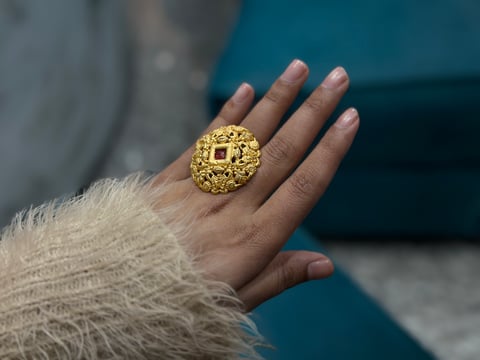 A woman wears a large one gram gold ring, the lighter jewellery Indian buyers turn to at the gold rate today