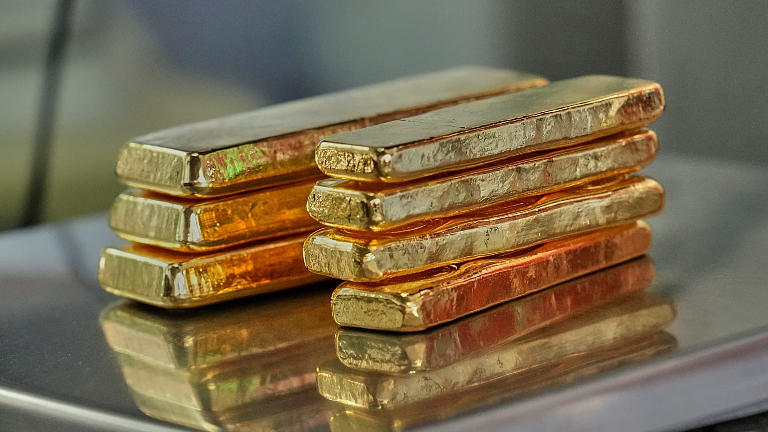 A gold trader weighs gold bars for sale, the bullion form that tracks the 24 carat gold rate today most closely