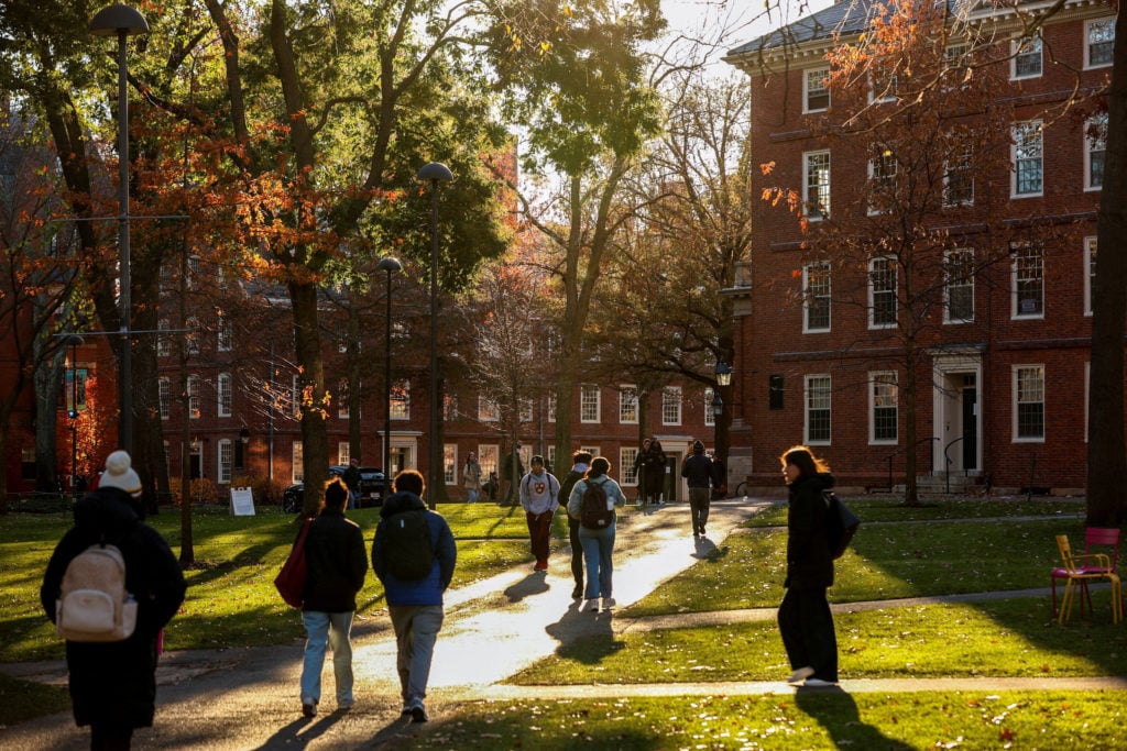 Students walking on Harvard University campus in Cambridge Massachusetts amid Trump DOJ antisemitism lawsuit dismissed by federal judge