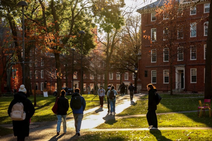 Students walking on Harvard University campus in Cambridge Massachusetts amid Trump DOJ antisemitism lawsuit dismissed by federal judge