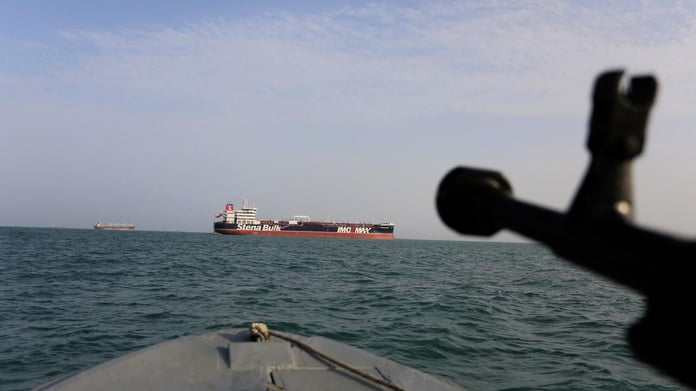 Iranian Revolutionary Guard speedboat patrols the Strait of Hormuz where Iran now blacklists non-compliant vessels