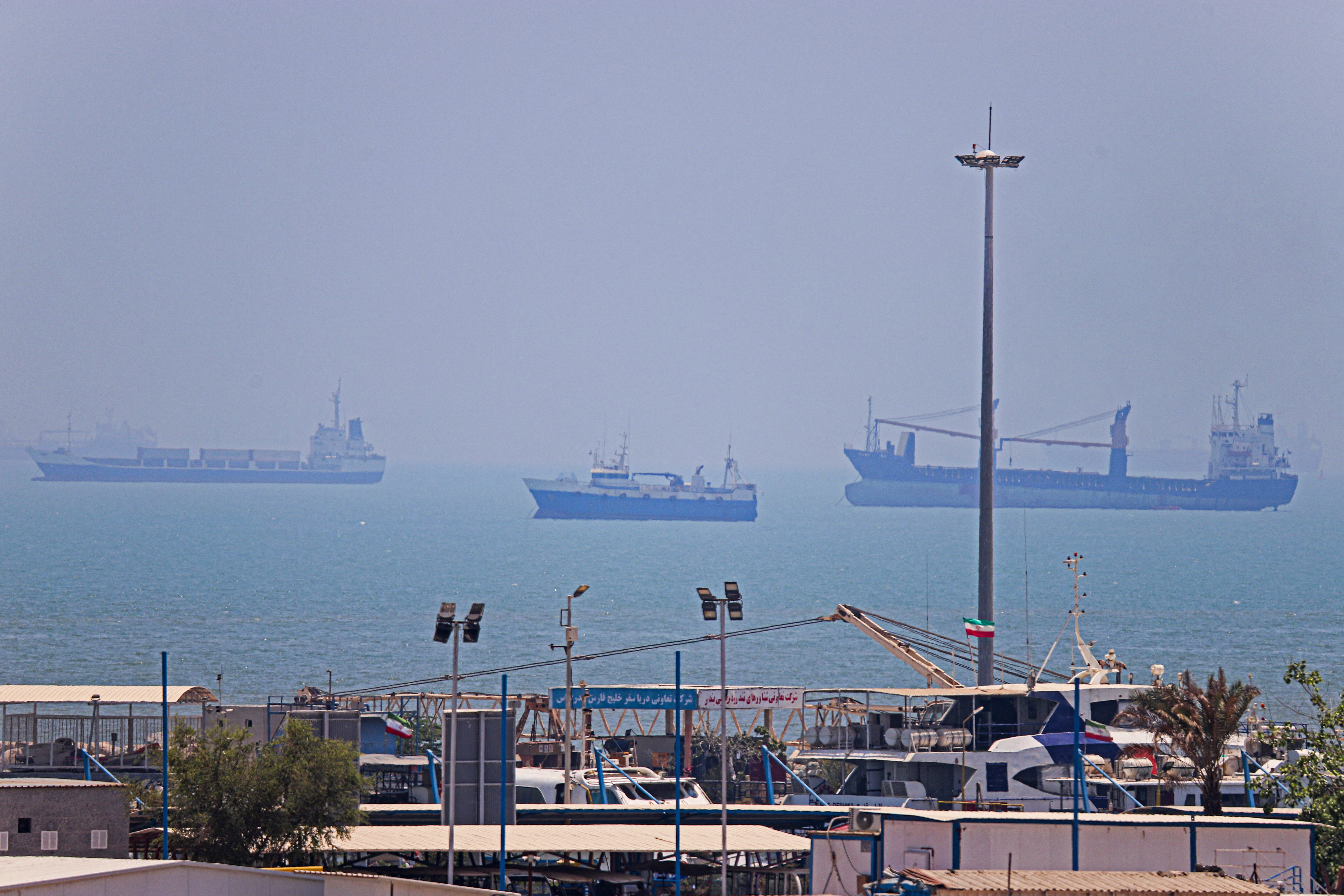 Commercial vessels anchored in Bandar Abbas along the Strait of Hormuz as the US naval blockade of Iran continues