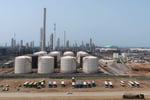 Oil storage tanks representing the economic stakes of US maximum pressure campaign against Iran and China detente risk