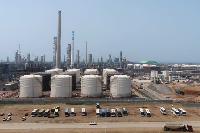 Oil storage tanks representing the economic stakes of US maximum pressure campaign against Iran and China detente risk