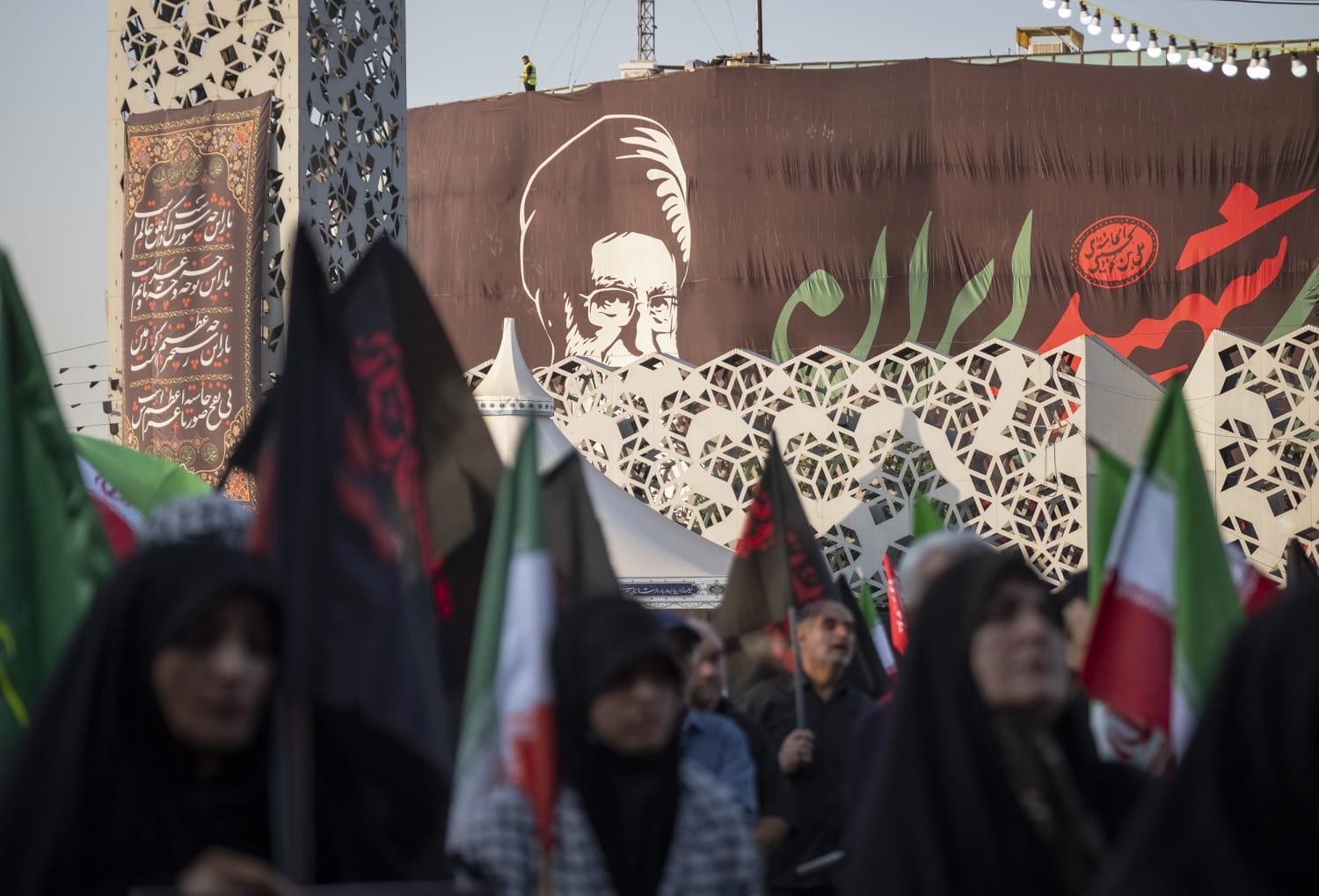 Iranians gather beneath a portrait of the late Ayatollah Ali Khamenei in Tehran as US-Iran indirect negotiations enter their final stage