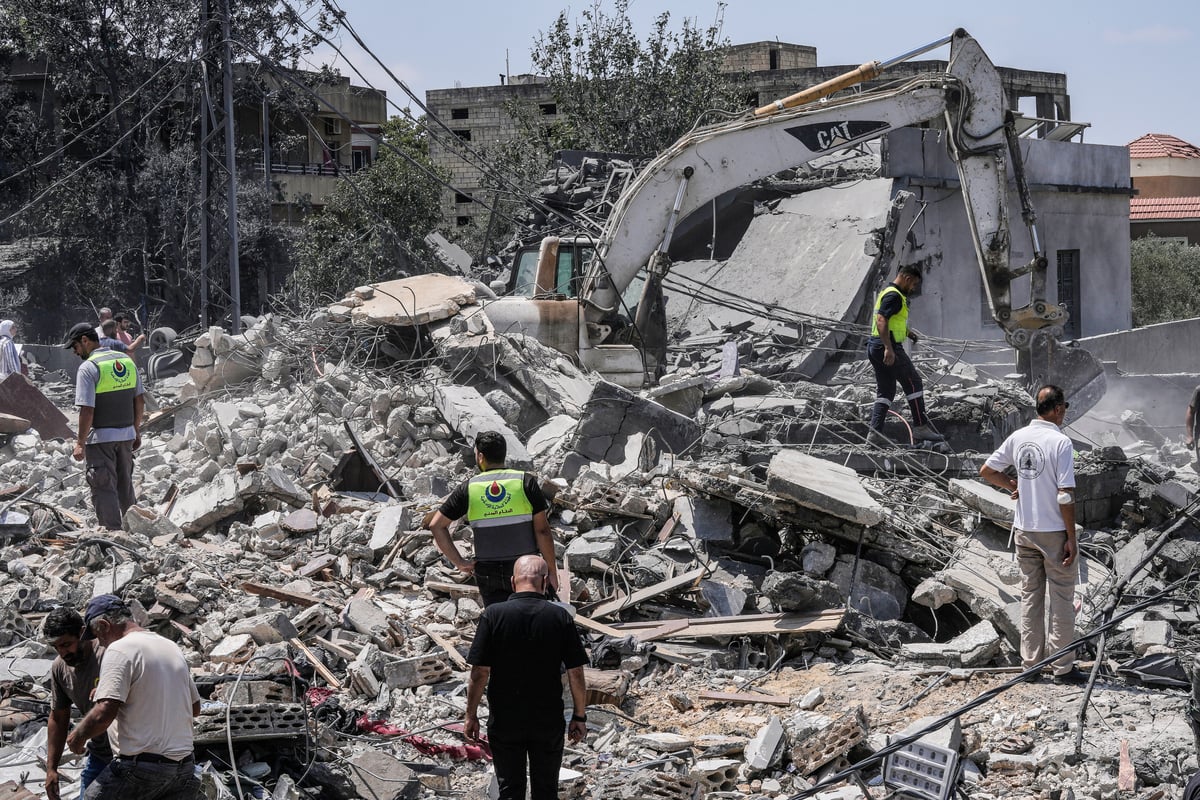 Rescue workers search rubble of destroyed house in Deir al-Zahrani Lebanon after Israeli airstrike August 15 2026