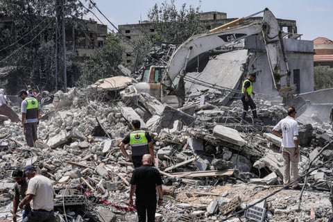 People and rescue workers gather at a destroyed house in Deir al-Zahrani in southern Lebanon after Israeli airstrike August 2026