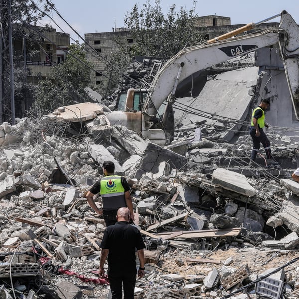 People and rescue workers gather at a destroyed house in Deir al-Zahrani in southern Lebanon after Israeli airstrike August 2026