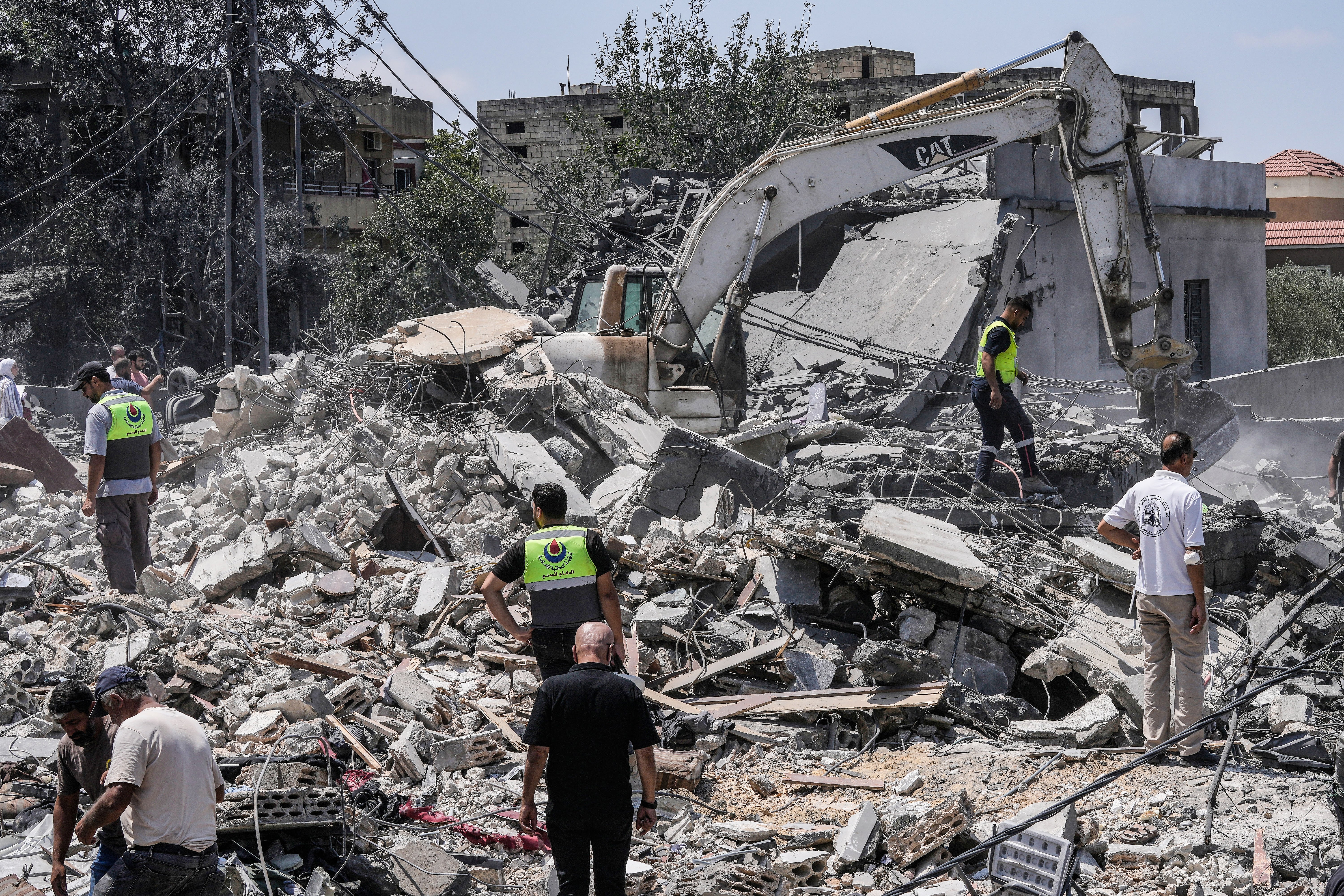 People and rescue workers gather at a destroyed house in Deir al-Zahrani in southern Lebanon after Israeli airstrike August 2026
