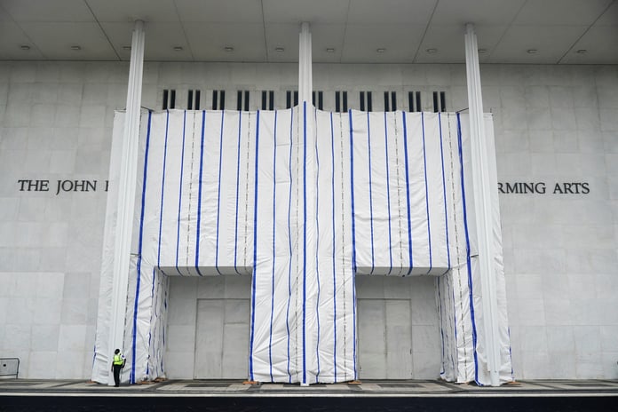 A tarp covers the facade of the John F. Kennedy Center for the Performing Arts after a federal judge ordered Trump name removed June 2026