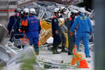 Rescue workers conduct search operations at the damaged Aeon Mall in Kashima Town, Kumamoto, Japan after the 7.1-magnitude earthquake