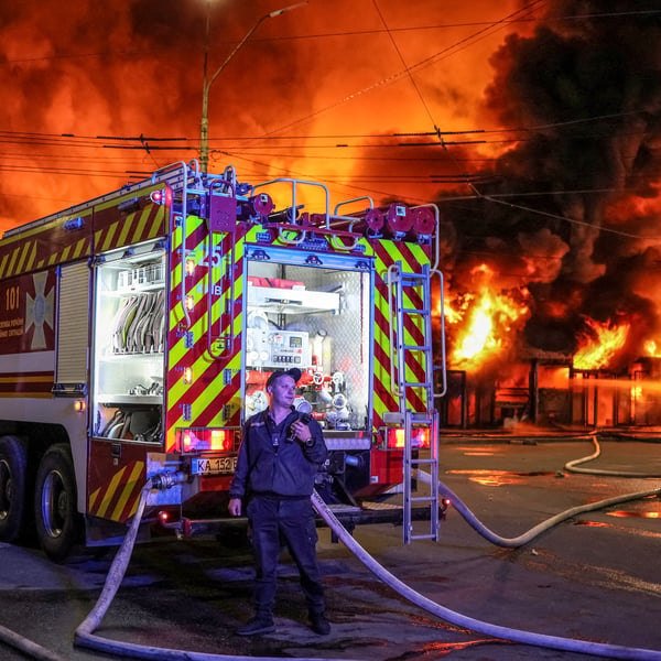 Firefighters work at a Kyiv book market destroyed by a Russian missile strike on August 16, 2026