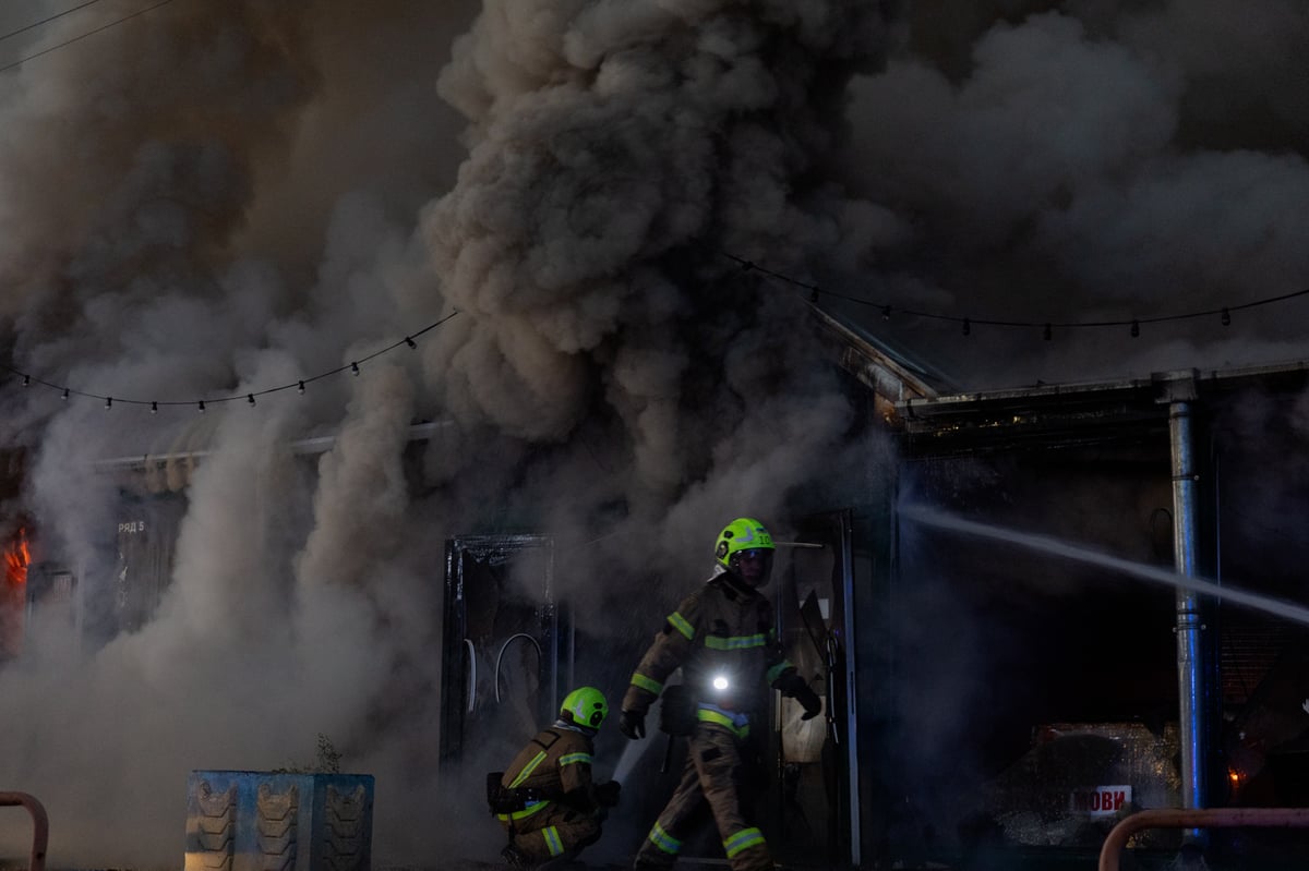Ukrainian rescuers work at the site of a Russian strike in Kyiv on August 16, 2026