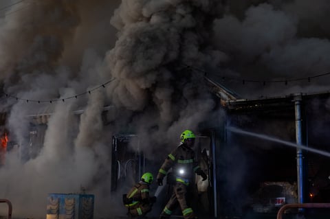 Ukrainian rescuers work at the site of a Russian strike in Kyiv on August 16, 2026