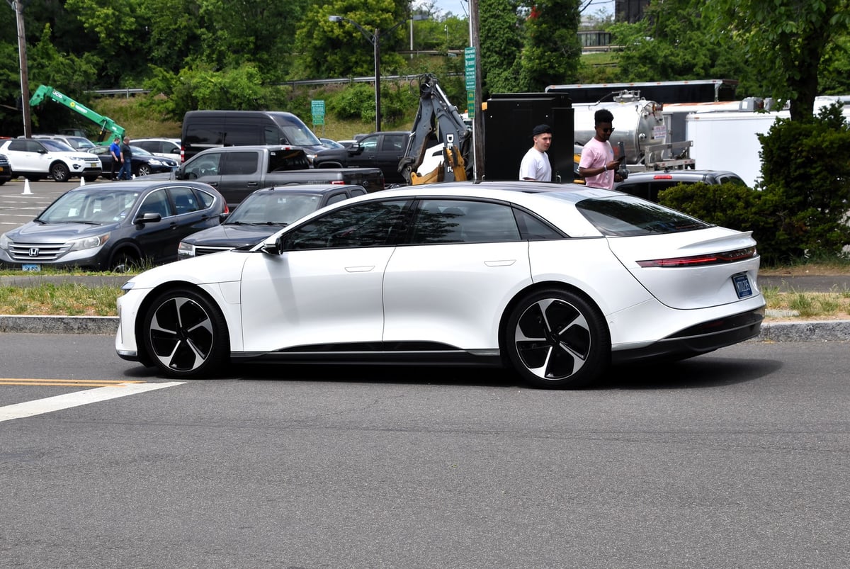 Lucid Air 2022 electric vehicle in light metallic finish shown at an automotive showcase