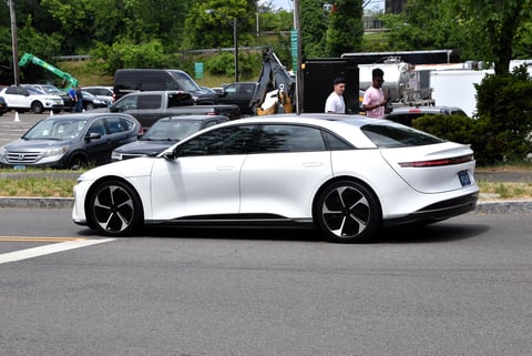 Lucid Air 2022 electric vehicle in light metallic finish shown at an automotive showcase