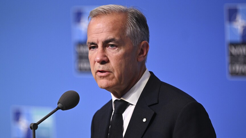 Canadian Prime Minister Mark Carney speaks at a NATO summit as the US-Canada trade war escalates