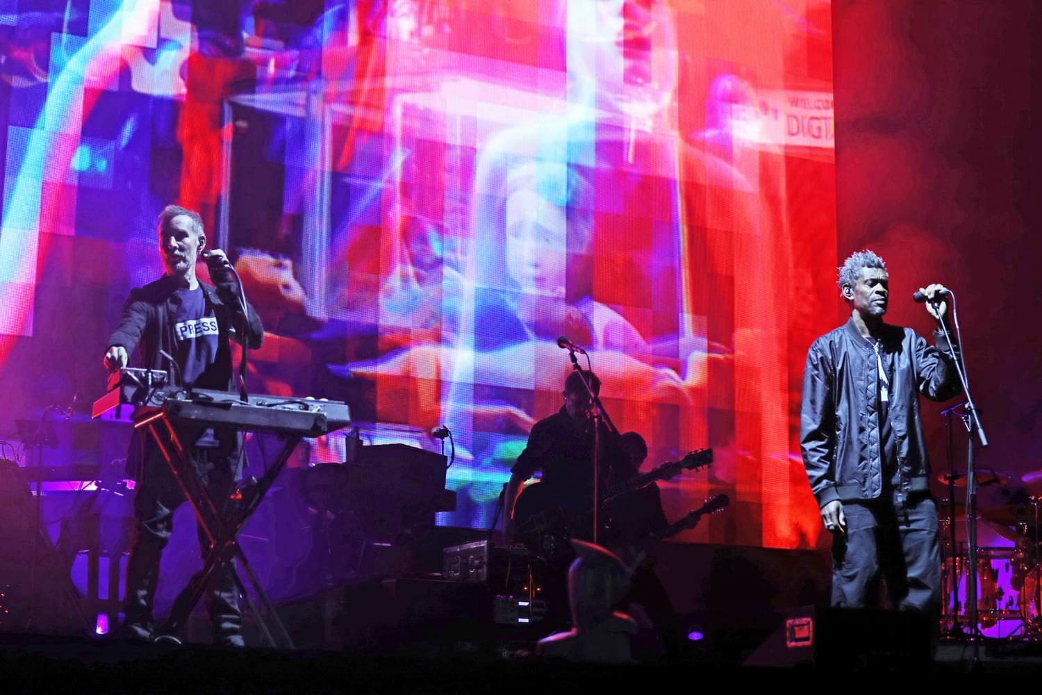 Massive Attack performance in Singapore on August 3 2026 where members raised a Palestinian flag and were later detained by police
