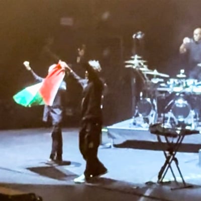 Massive Attack members Robert Del Naja and Grant Marshall perform at a concert before being detained by Singapore police for raising a Palestinian flag