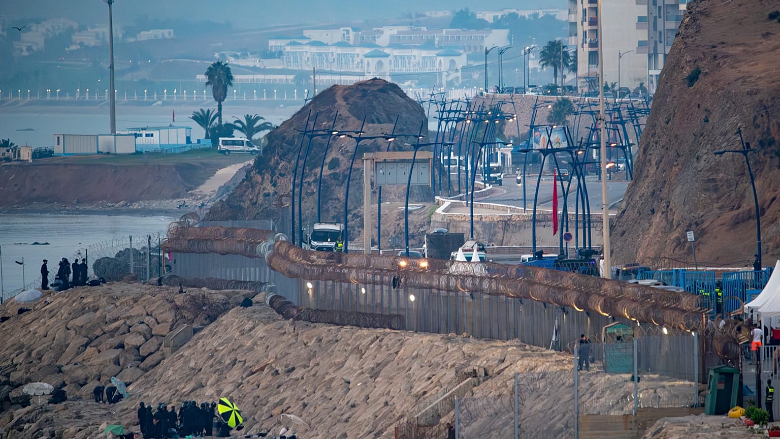 Moroccan security forces and navy fast boats deployed near the Ceuta border fence to block a social-media-organized mass crossing attempt on August 16, 2026