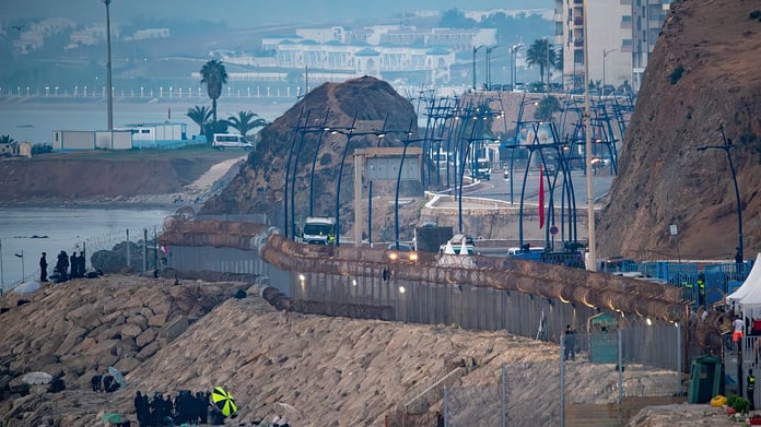 Moroccan security forces and navy fast boats deployed near the Ceuta border fence to block a social-media-organized mass crossing attempt on August 16, 2026