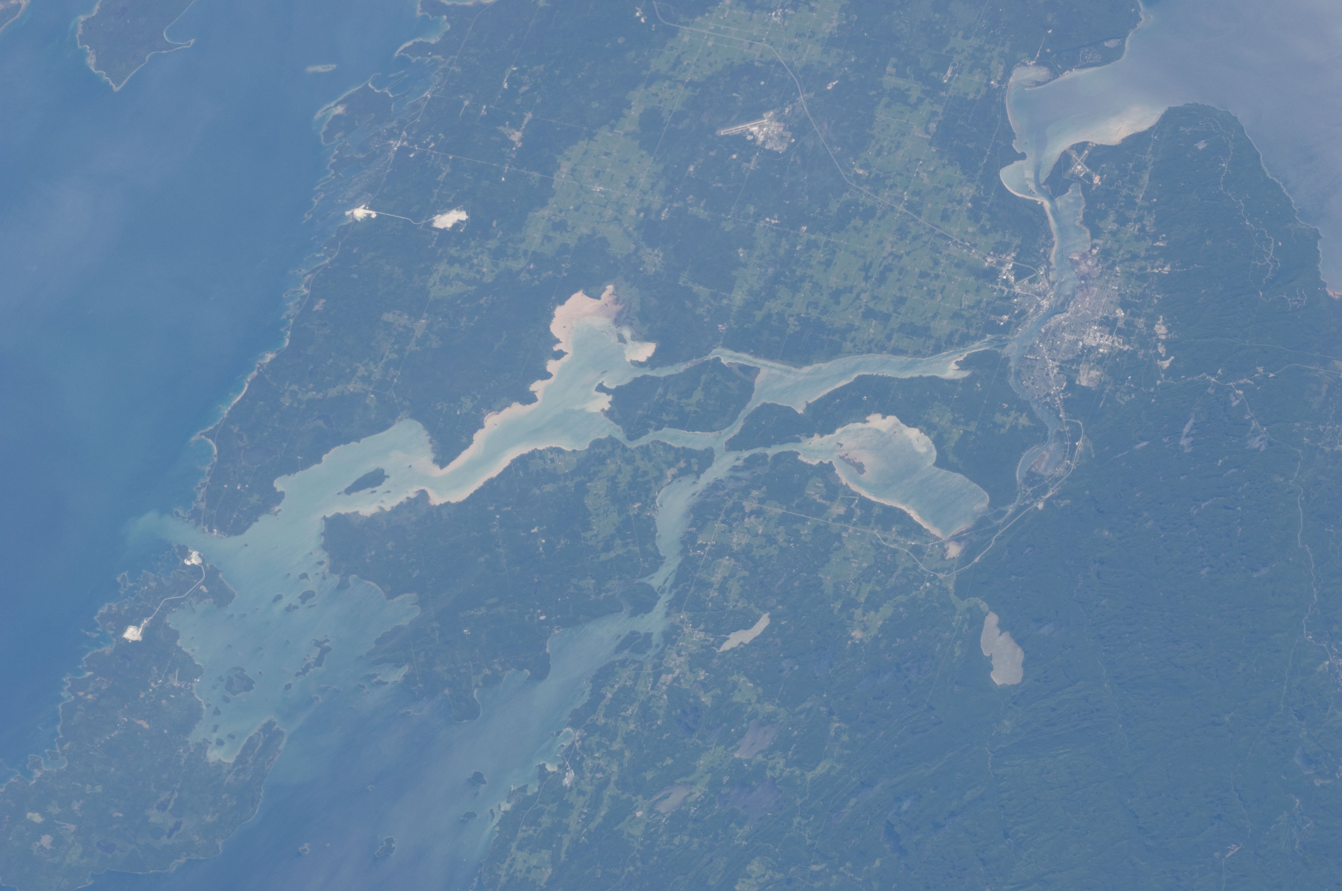 International Space Station photograph of Sault Ste Marie Michigan showing the St Marys River connecting Lake Huron and Lake Superior Great Lakes water supply