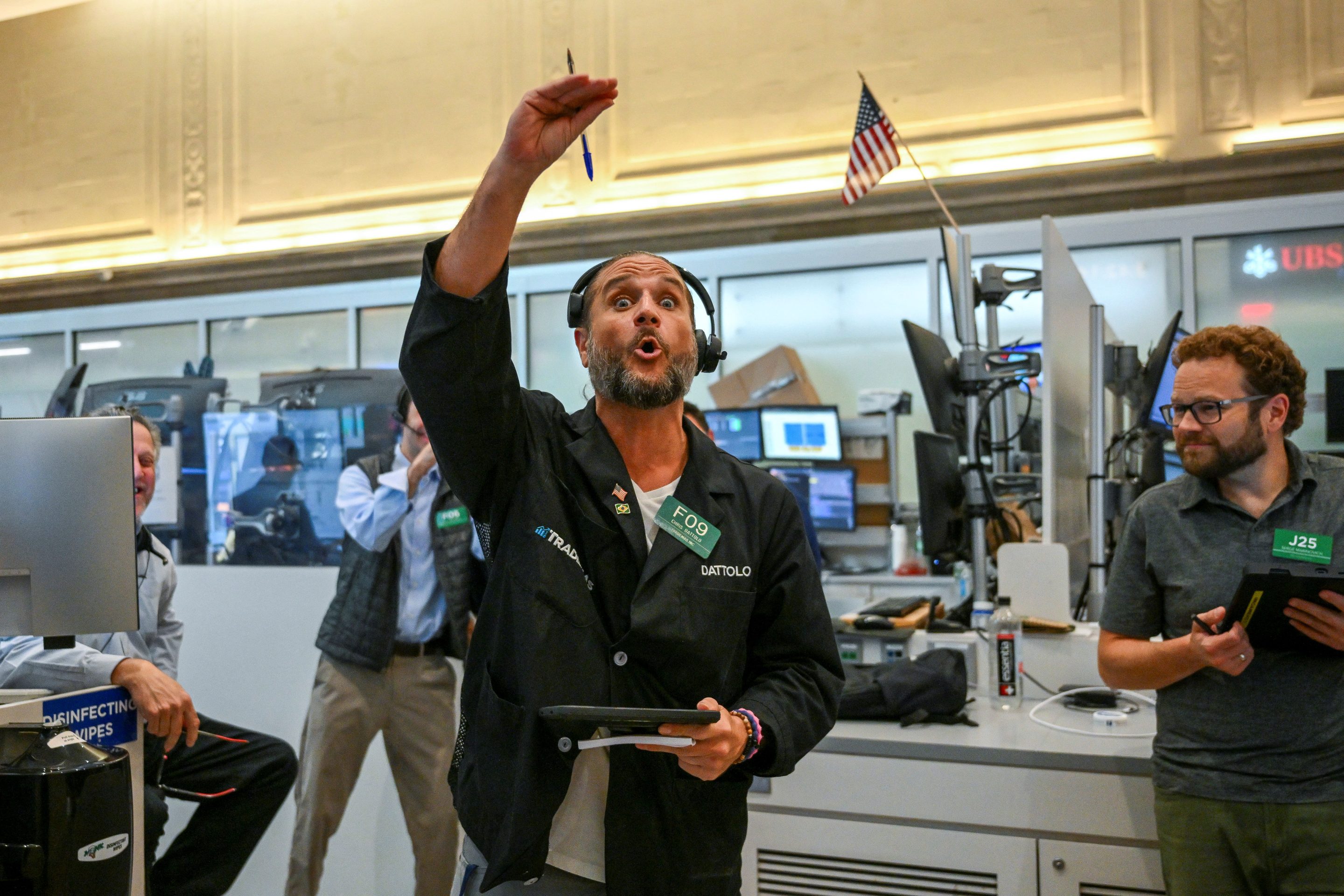 Nasdaq Composite today: a trader signals on the floor of the New York Stock Exchange during a US session