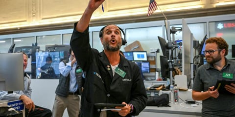 Nasdaq today: a trader signals on the floor of the New York Stock Exchange during a volatile session