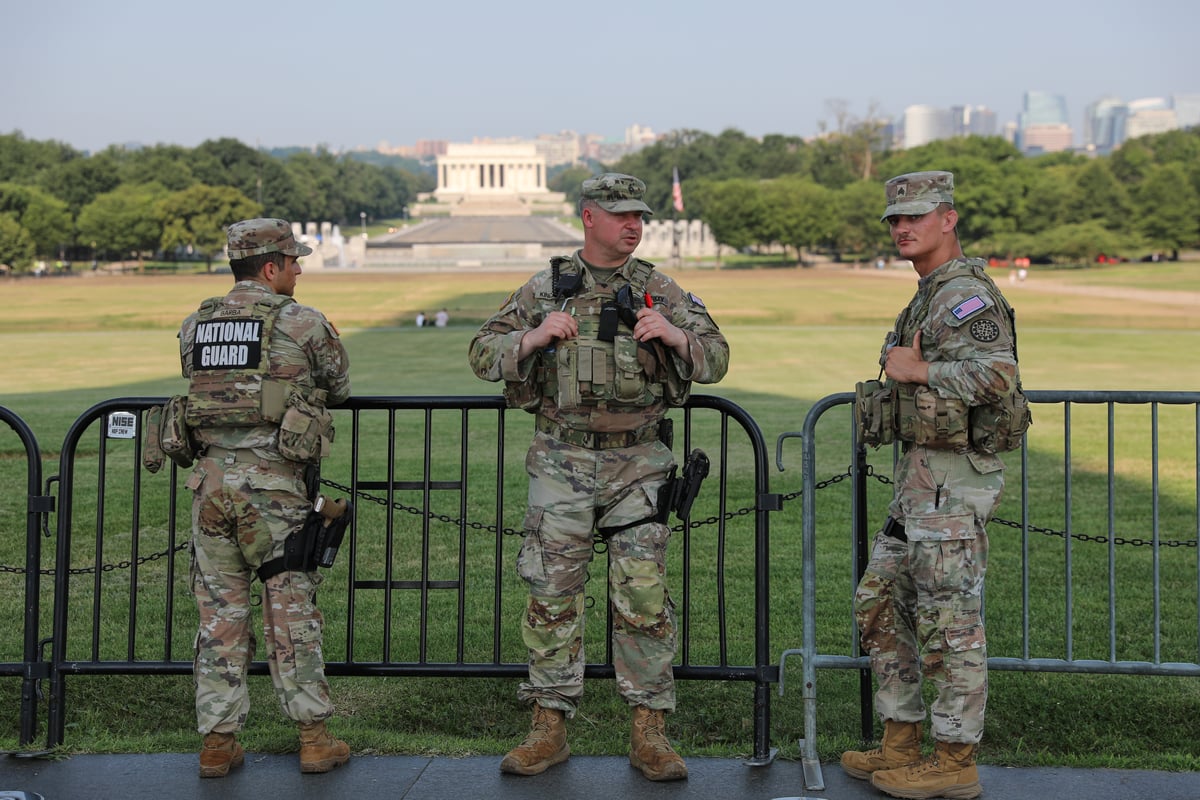 Members of the US National Guard patrol at the base of the Washington Monument in Washington DC