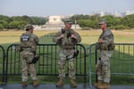 Members of the US National Guard patrol at the base of the Washington Monument in Washington DC