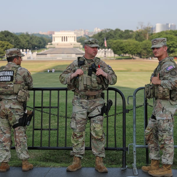 Members of the US National Guard patrol at the base of the Washington Monument in Washington DC