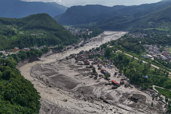 Damaged houses beside the debris-choked Trishuli River in Nepal's Nuwakot district after the flash floods