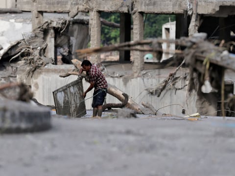 Rescuers search for survivors along Nepal's flooded Trishuli River valley after a glacier collapse in Rasuwa district, August 2026