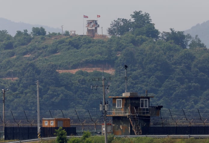 North Korean soldier stands guard at post inside North Korean territory viewed from Paju South Korea near the Demilitarized Zone