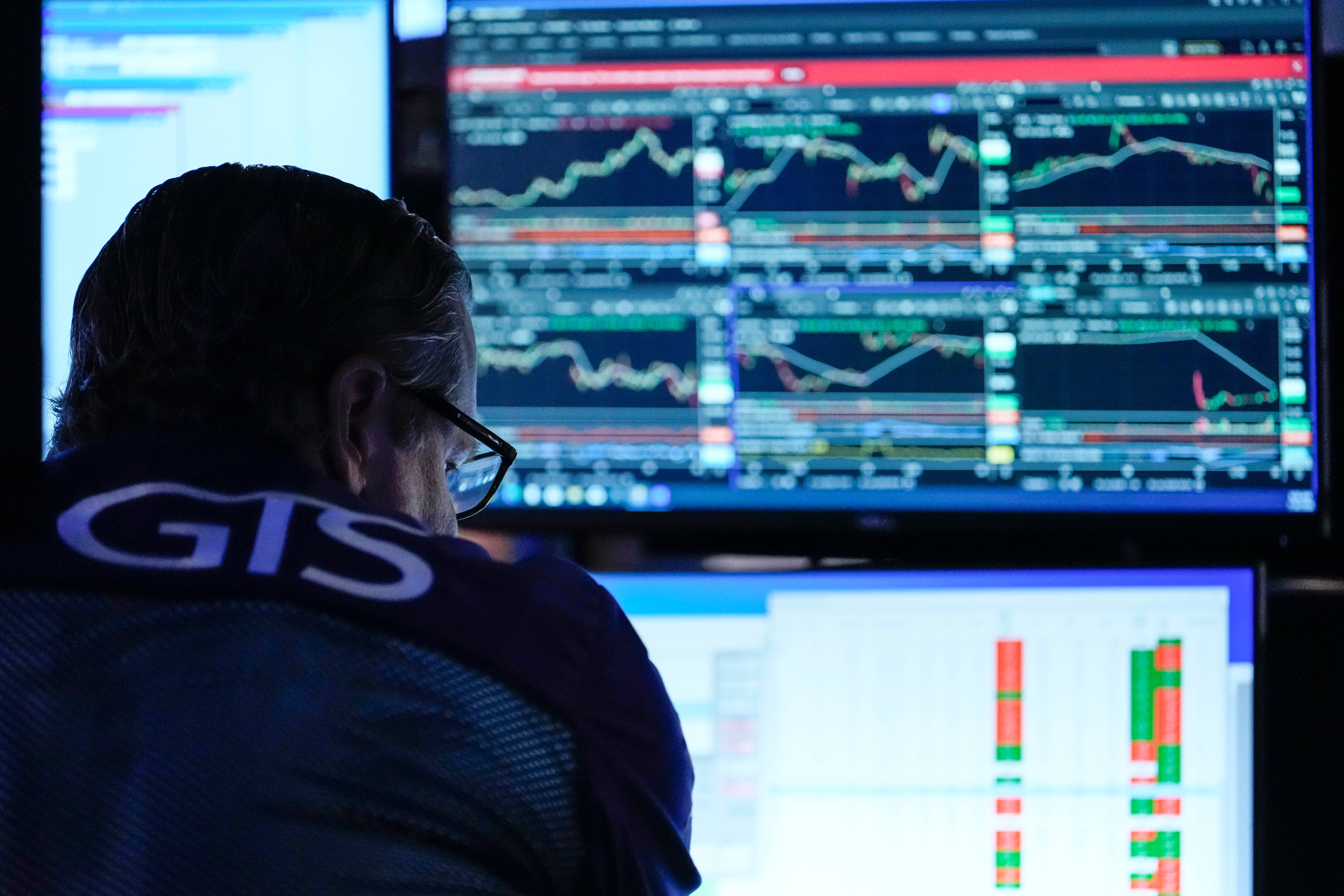 Trader on New York Stock Exchange floor as OpenAI executive departure raises questions about company valuation and leadership