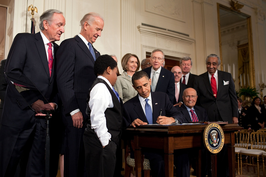 President Barack Obama signing the Affordable Care Act in the East Room of the White House in March 2010