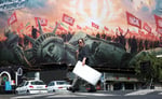 An anti-US billboard on a Tehran street as the US-Iran memorandum expires and oil prices today hold near $88 a barrel