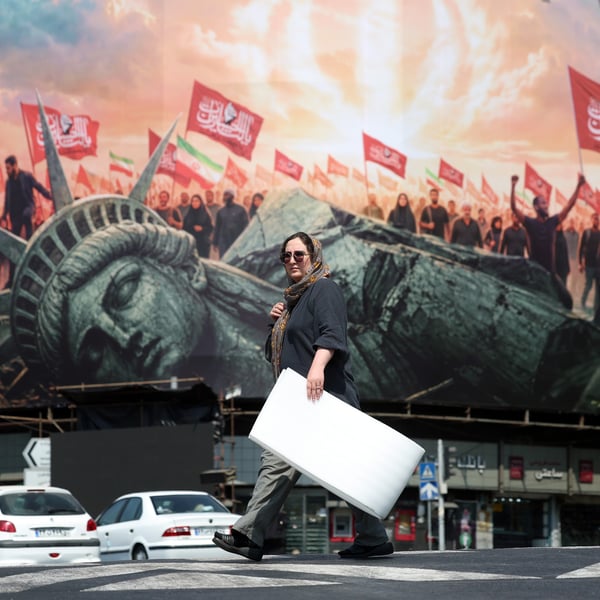 An anti-US billboard on a Tehran street as the US-Iran memorandum expires and oil prices today hold near $88 a barrel