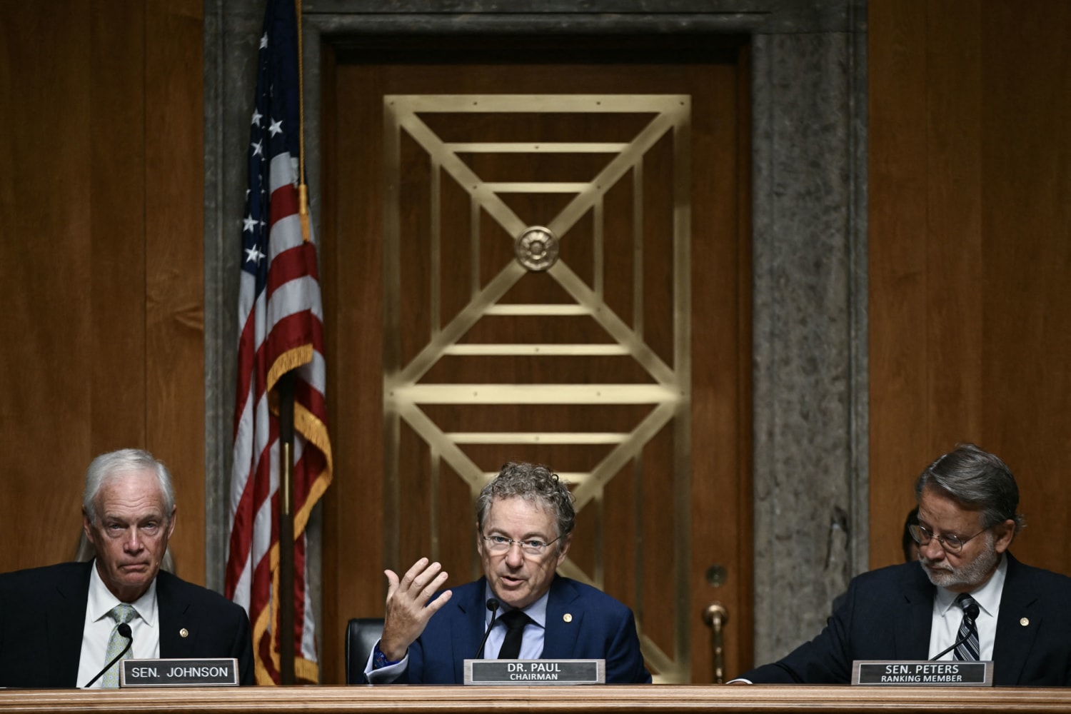 Senator Rand Paul flanked by Ron Johnson and Gary Peters at Senate Fauci contempt vote 2026