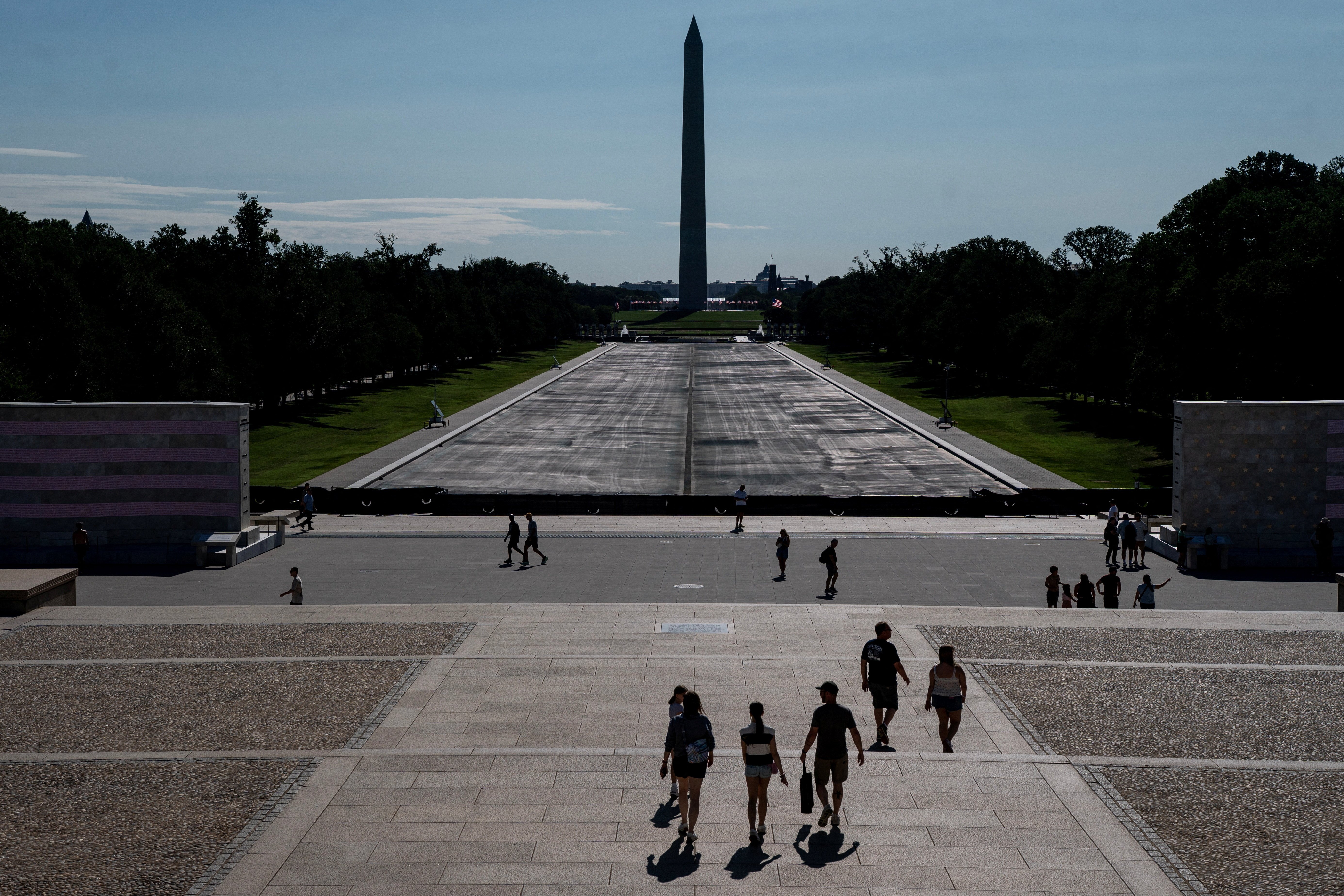 Visitors walk near the drained Lincoln Memorial Reflecting Pool in Washington DC after Trump botched renovation
