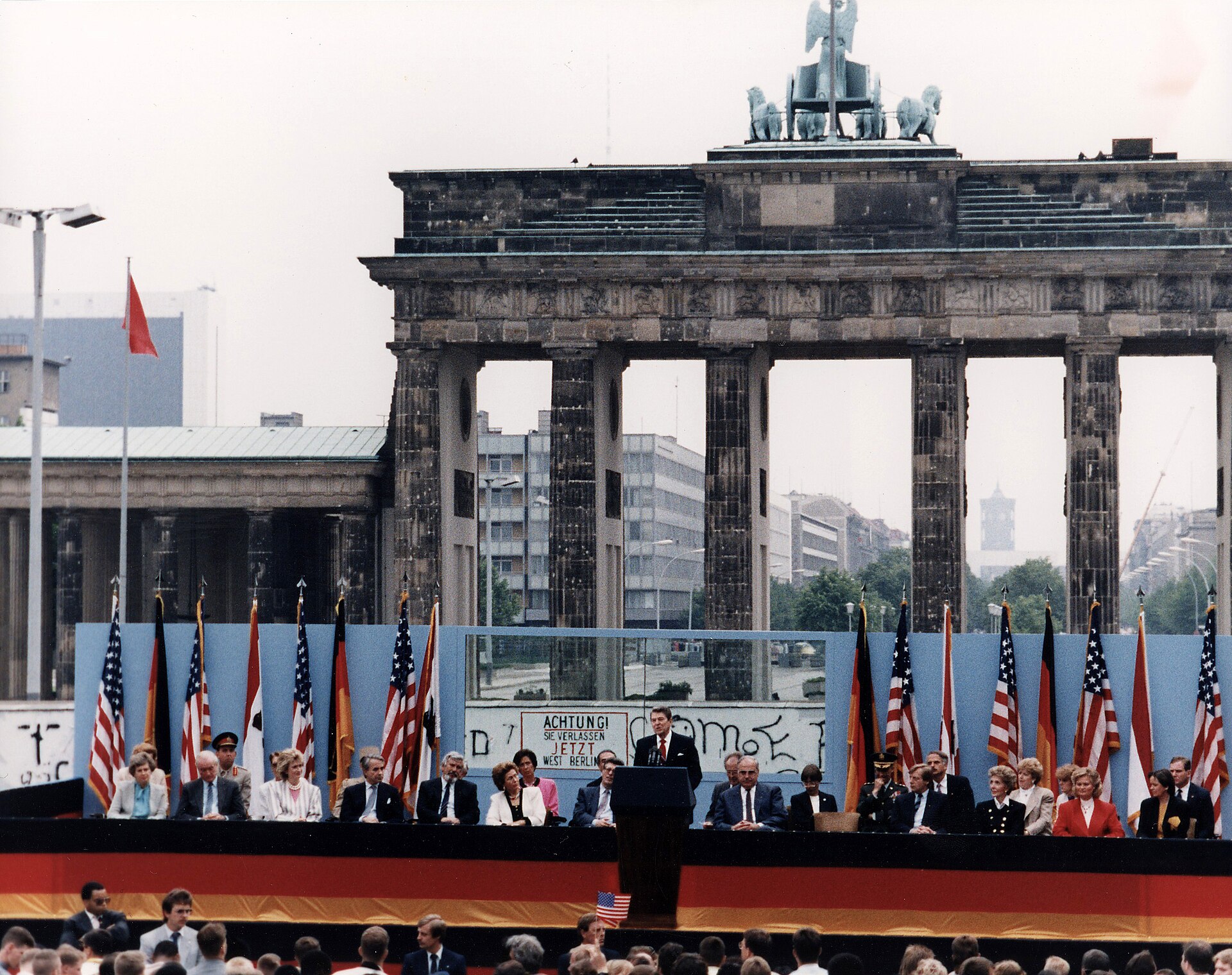 Ronald Reagan speaking from a podium in front of the Brandenburg Gate in West Berlin on 12 June 1987