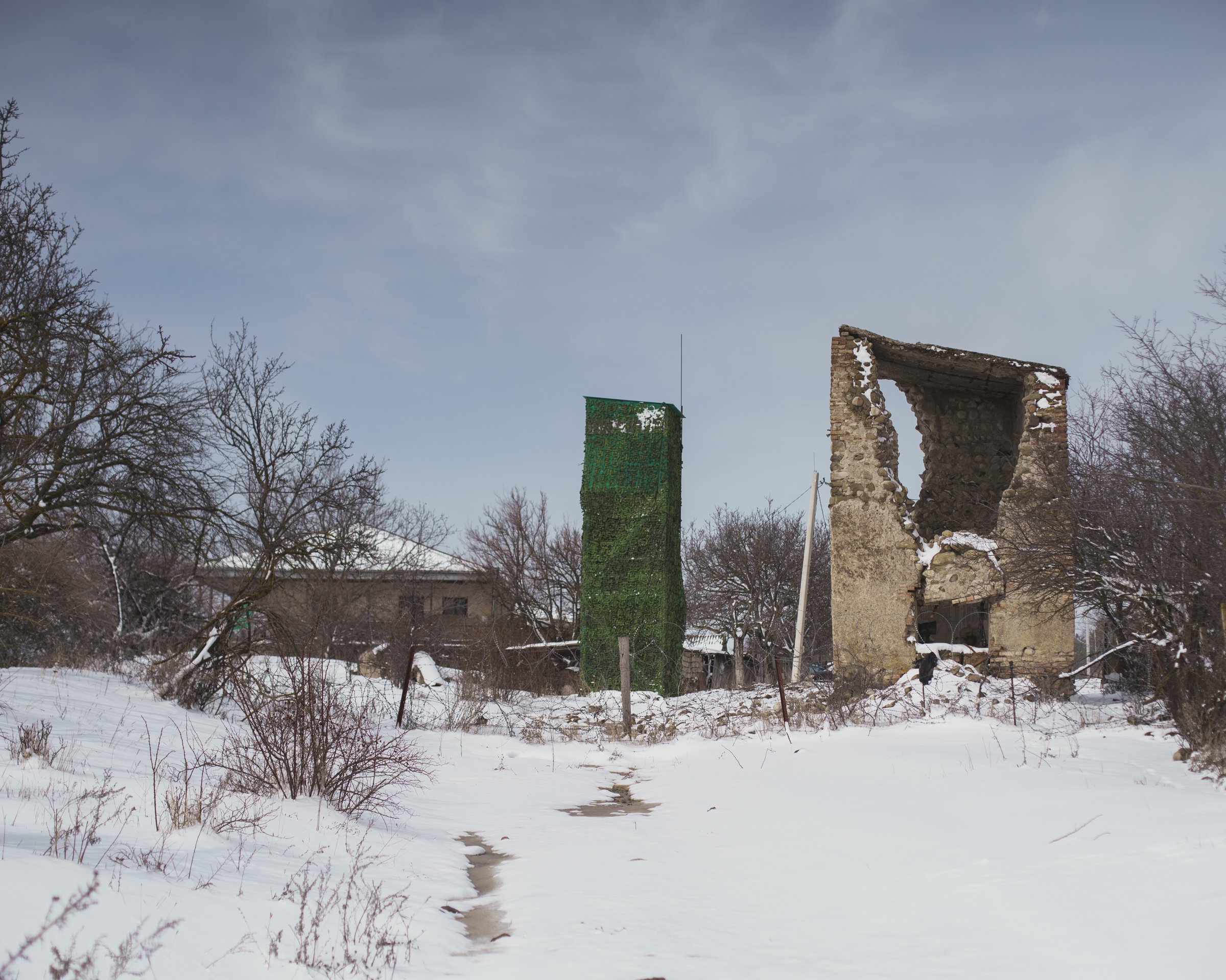 A camouflaged Russian observation post behind barbed wire on the boundary line beside Khurvaleti in Georgia