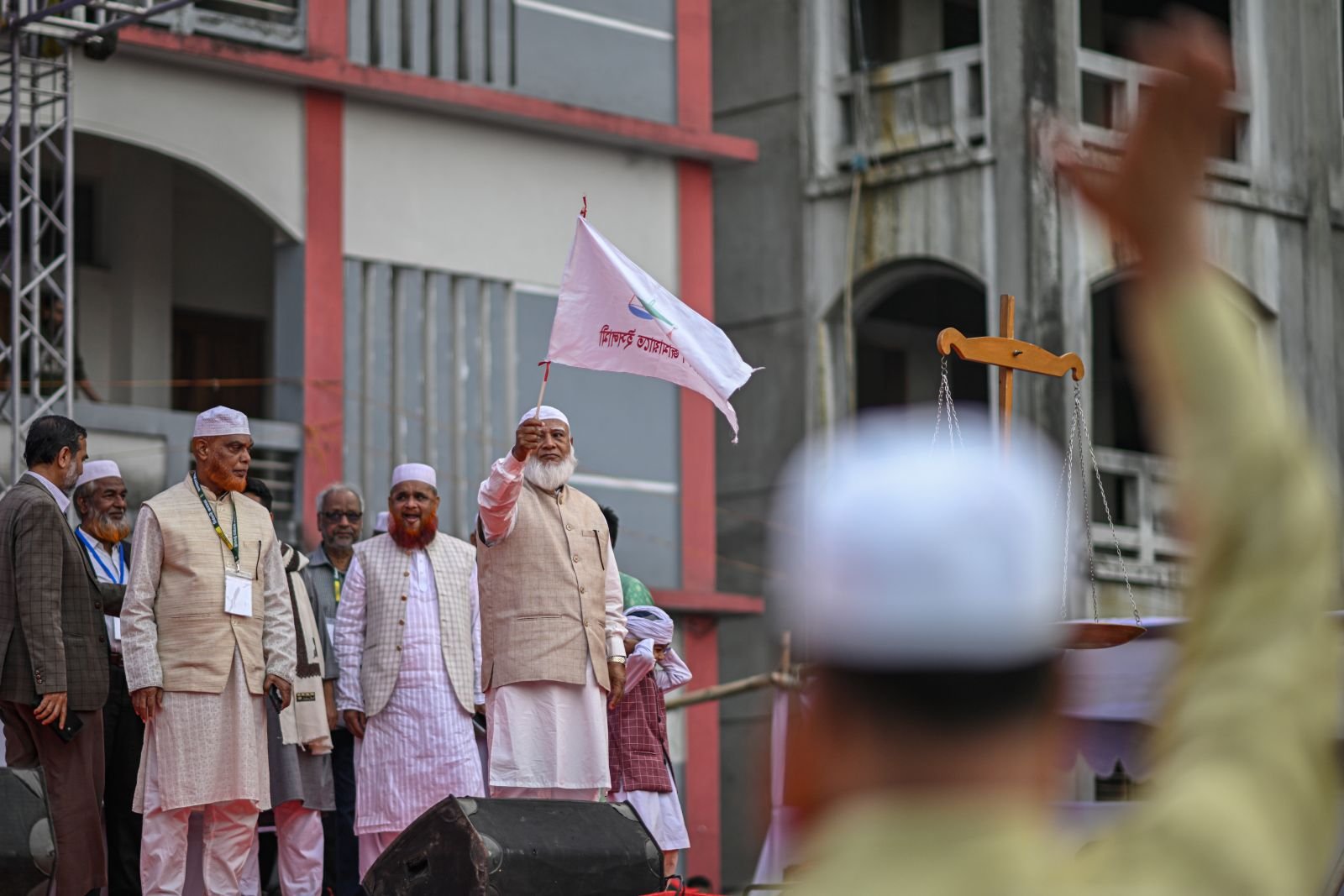 Shafiqur Rahman waves the Jamaat-e-Islami party flag during an election campaign in Dhaka