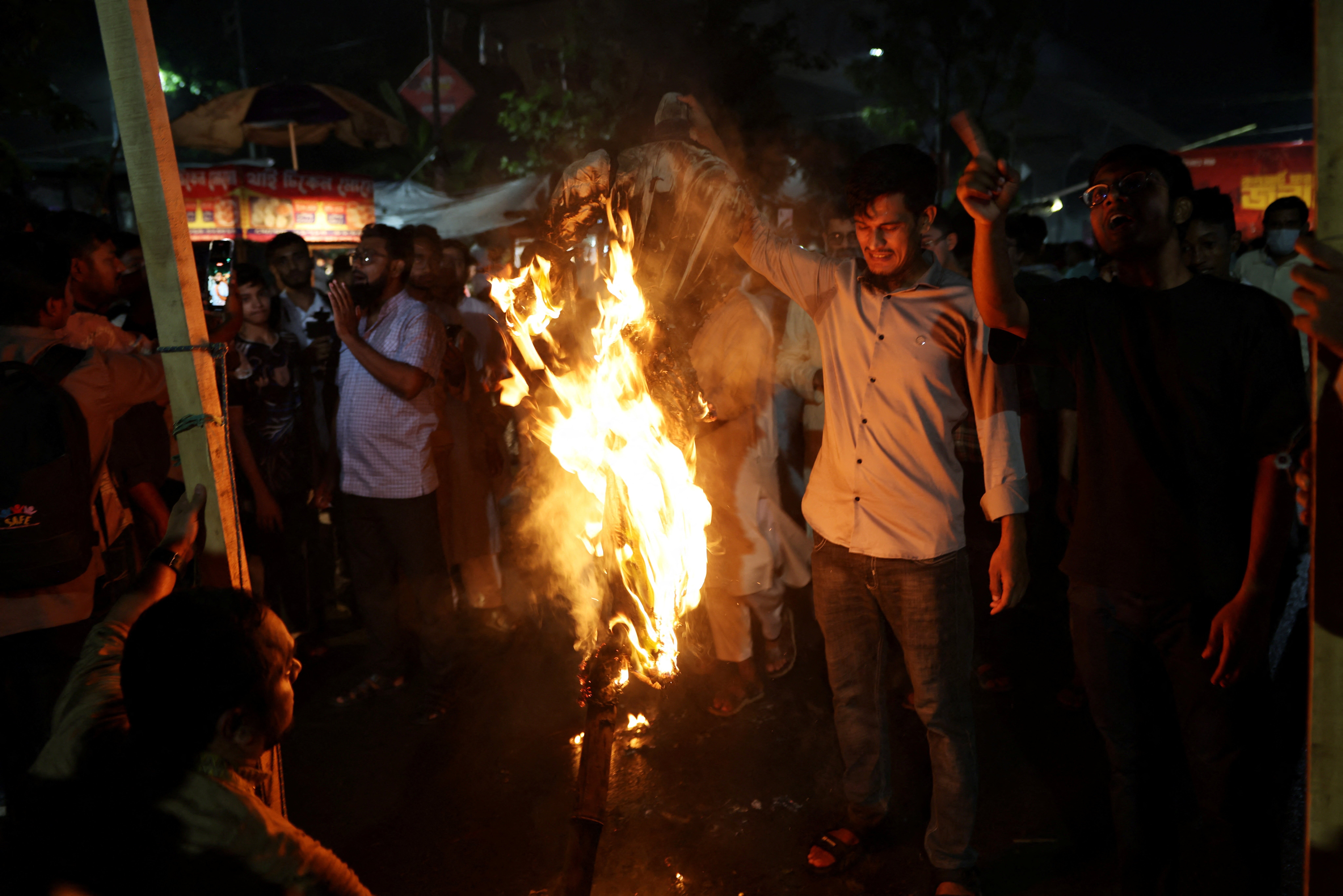 Protesters burn an effigy of Sheikh Hasina during demonstrations in Dhaka Bangladesh August 2026