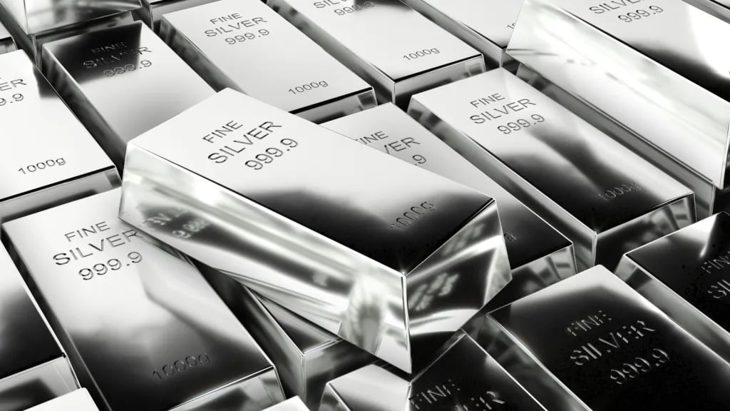 An employee displays a silver bar in a safe deposit room, the metal behind the silver rate today quoted across Indian cities