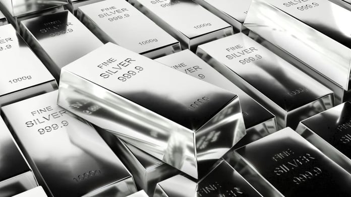 An employee displays a silver bar in a safe deposit room, the metal behind the silver rate today quoted across Indian cities